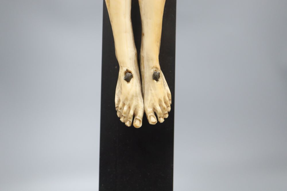 A carved ivory and ebony crucifix, height 59cm